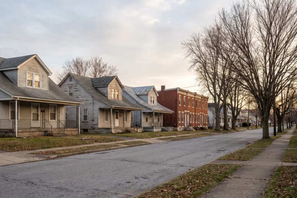Older detached homes and rowhouses on a Claymont block