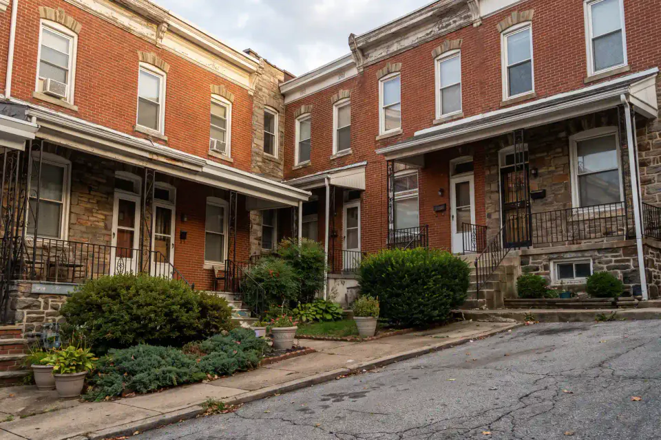 Older brick rowhomes climbing a residential street in Conshohocken, PA