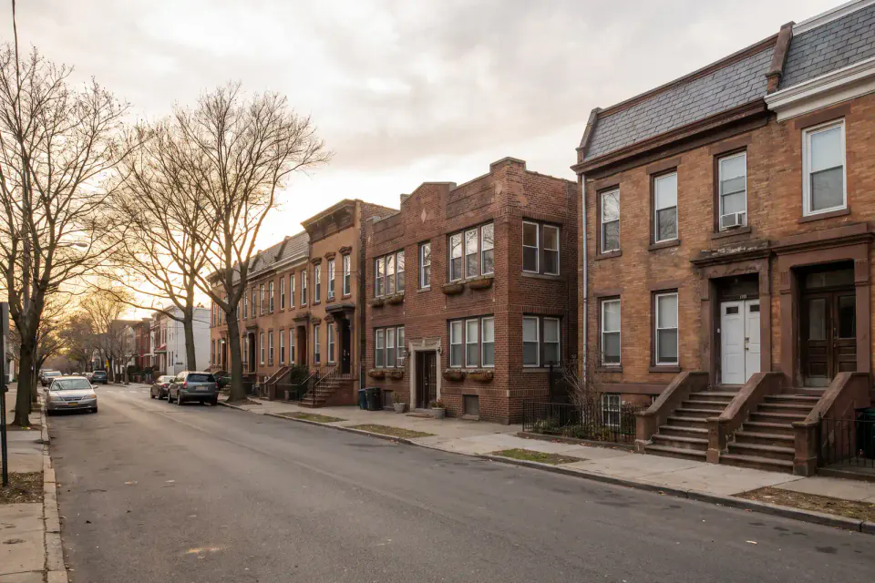 Older attached homes and multifamily buildings on a Newark block