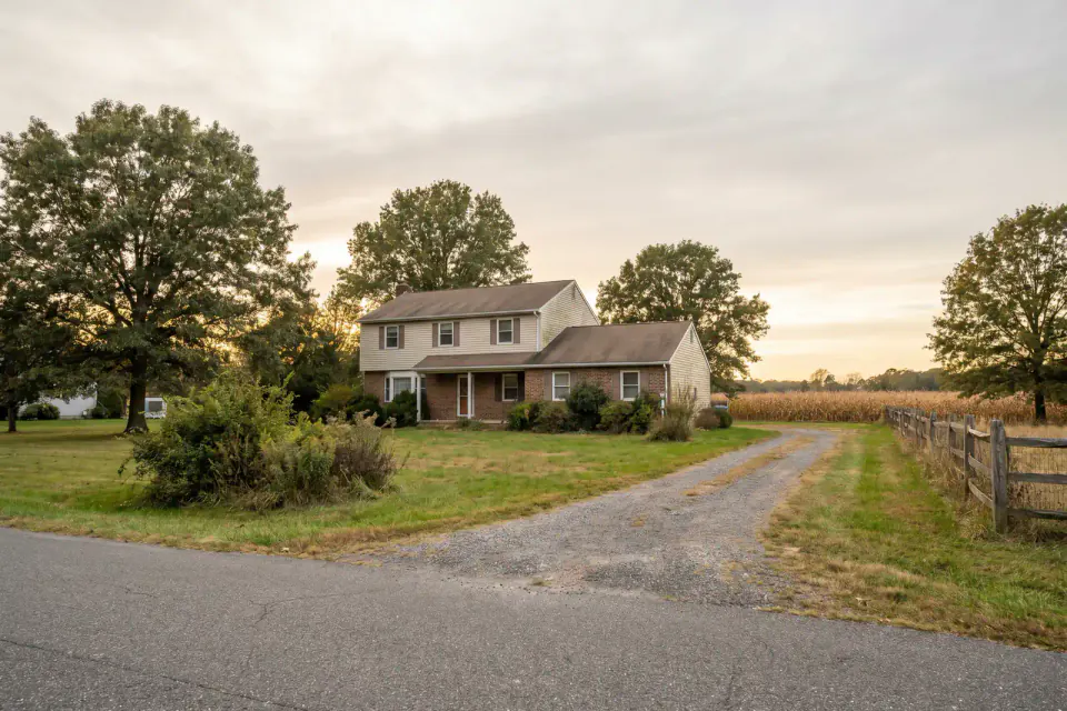 Modest detached home on a broad Vineland lot near farmland